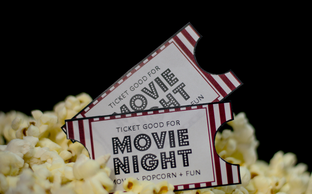 The image is of two movie tickets sticking out from a pile of popcorn. The image accompanies a blog post about how life insurance fraud is portrayed in movies